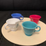 Some of the components for a teacup ride - 4 t-cups and a round piece of wood