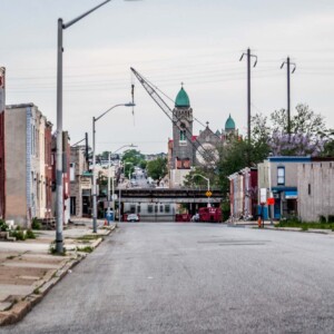 A view from baltimore A street in Baltimore with many abandoned buildings. A church behind an elevated highway